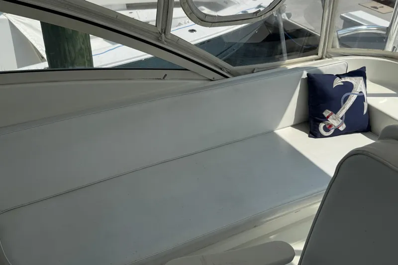  Yacht Photos Pics 1999 Ocean Yachts 40 Express interior with white seating and anchor-themed pillow.