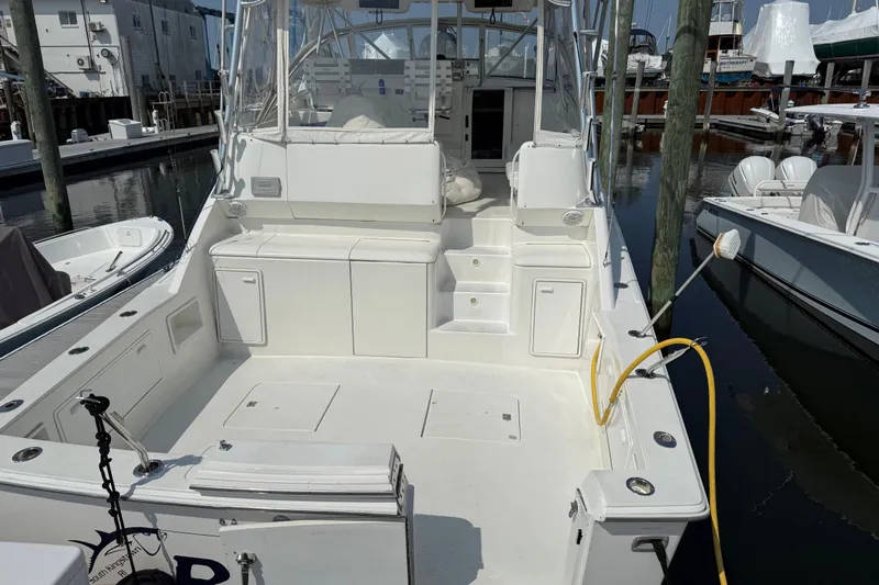  Yacht Photos Pics 1999 Ocean Yachts 40 Express boat docked, featuring spacious deck and seating area.