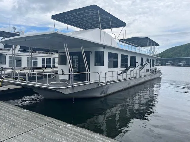 1992 Lakeview houseboat docked on calm water, featuring spacious decks and modern design.