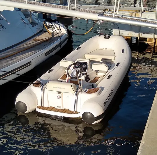 Alchemist Yacht Photos Pics White Williams Turbojet tender docked beside a 1995 Mangusta motor yacht.