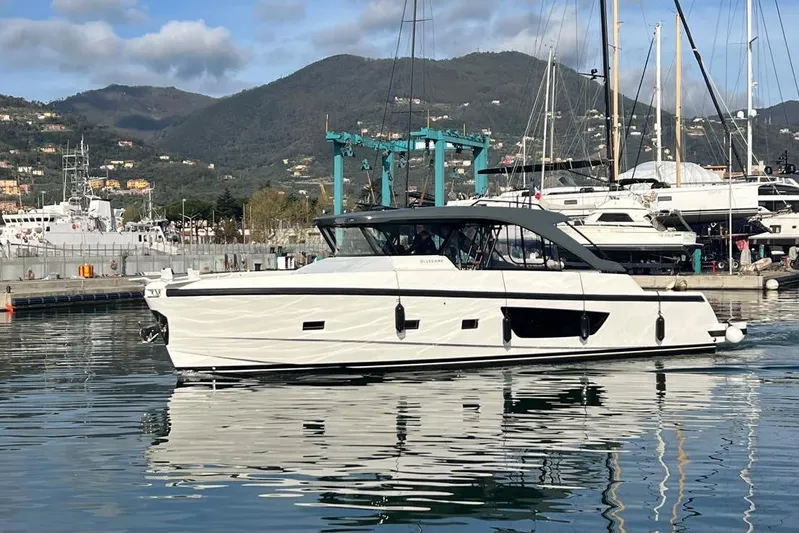  Yacht Photos Pics 2024 Bluegame BG54 yacht docked in a scenic marina with mountains in the background.