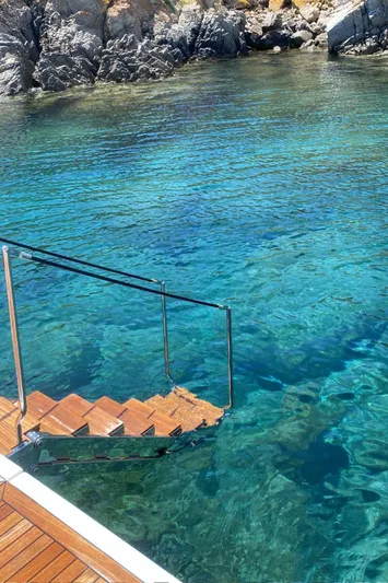  Yacht Photos Pics Staircase from Bluegame BG54 yacht leading into clear blue water, 2024 model.
