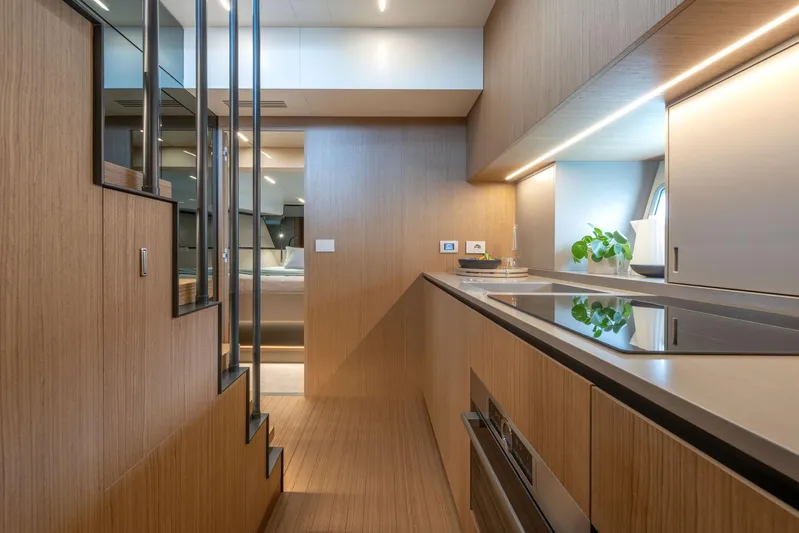  Yacht Photos Pics Modern kitchen interior of 2024 Bluegame BG54 yacht, featuring sleek wood finishes and contemporary design.