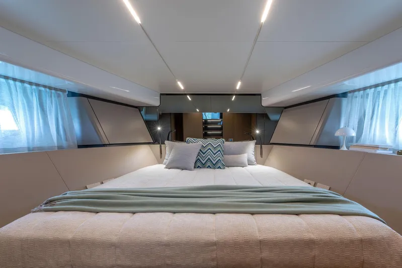  Yacht Photos Pics Luxurious interior of 2024 Bluegame BG54 yacht with elegant bedding and modern lighting.