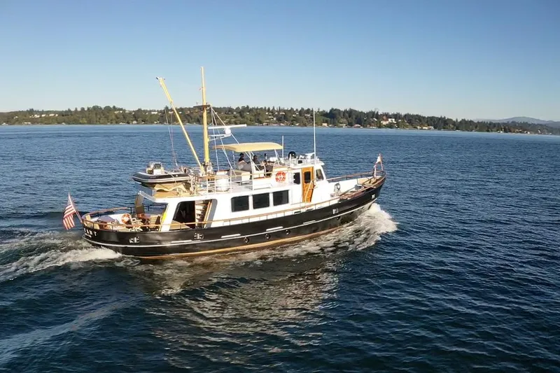  Yacht Photos Pics A 1974 Doggersbank 63 yacht cruising on a sunny day in open waters.
