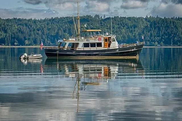  Yacht Photos Pics Vintage 1974 Doggersbank 63 yacht on serene lake with forested backdrop.