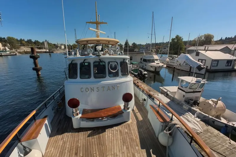  Yacht Photos Pics 1974 Doggersbank 63 yacht "Constant" docked at marina, surrounded by boats and clear blue sky.