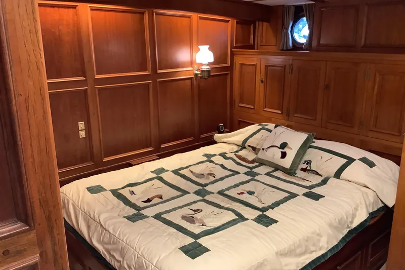  Yacht Photos Pics Cozy wooden cabin bedroom on 1974 Doggersbank 63 yacht with nautical decor.