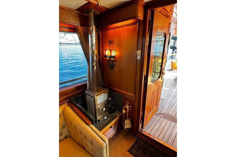  Yacht Photos Pics Cozy interior of 1974 Doggersbank 63 yacht with wood stove and elegant decor.