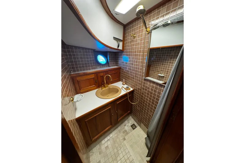  Yacht Photos Pics 1974 Doggersbank 63 yacht bathroom with wooden cabinetry and tiled walls.