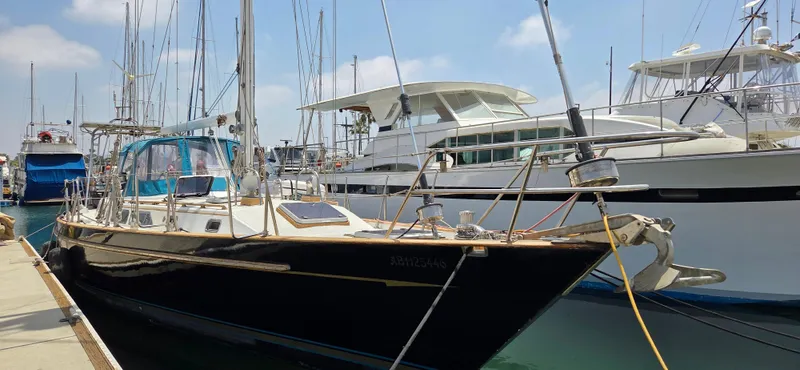  Yacht Photos Pics 1987 Tayana Center Cockpit yacht docked at marina, surrounded by other boats.