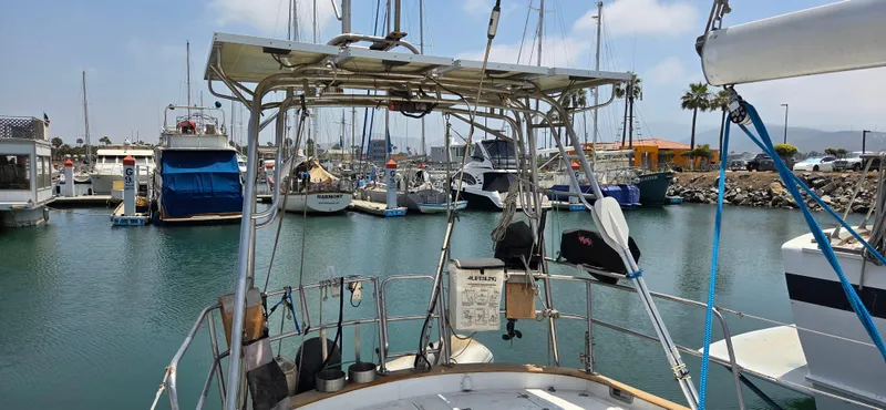  Yacht Photos Pics 1987 Tayana Center Cockpit sailboat docked in a marina with other boats.
