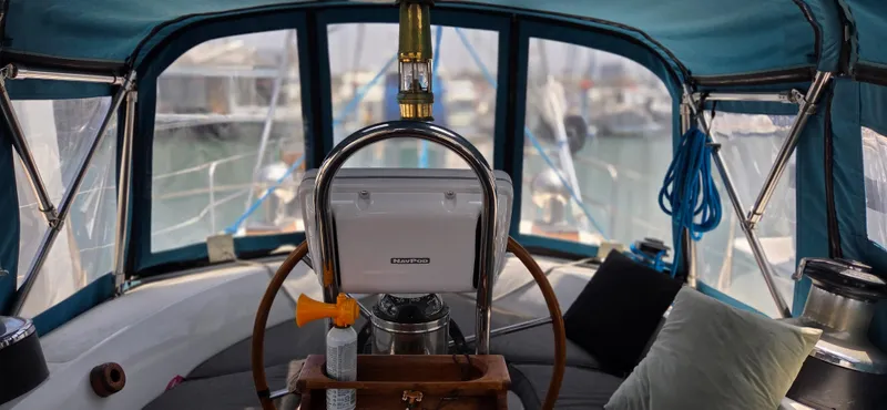  Yacht Photos Pics 1987 Tayana Center Cockpit interior with steering wheel and navigation equipment.