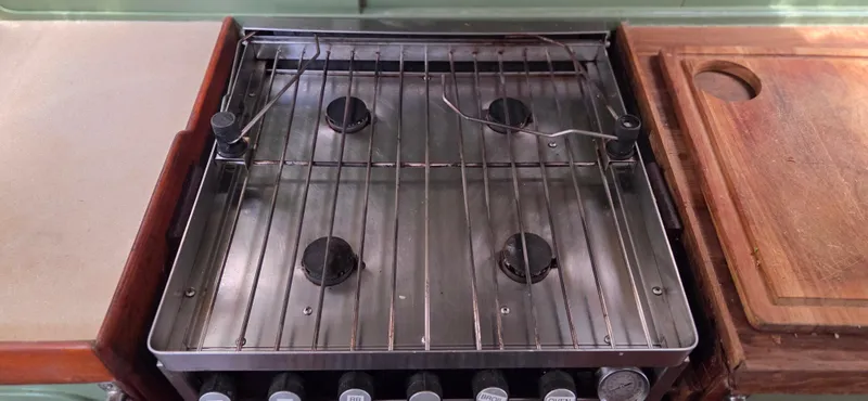  Yacht Photos Pics Stove in 1987 Tayana Center Cockpit yacht kitchen with wooden cutting board.