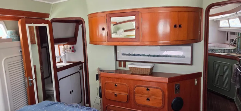  Yacht Photos Pics 1987 Tayana Center Cockpit interior with wooden cabinetry, bathroom, and cozy living space.