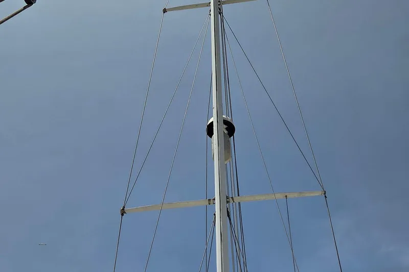  Yacht Photos Pics Mast of 1987 Tayana Center Cockpit sailboat against clear blue sky.