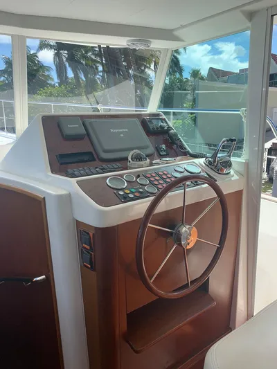  Yacht Photos Pics 2006 Beneteau Swift Trawler 42 helm with navigation controls and steering wheel.
