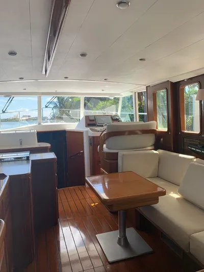  Yacht Photos Pics Interior of 2006 Beneteau Swift Trawler 42 with wood flooring and white seating.
