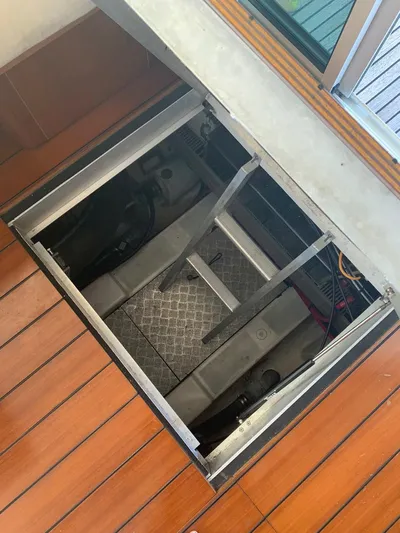  Yacht Photos Pics Engine compartment of 2006 Beneteau Swift Trawler 42 with open hatch on wooden deck.