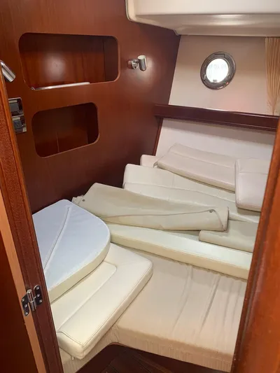 Yacht Photos Pics Interior cabin of 2006 Beneteau Swift Trawler 42 with cushions and porthole.
