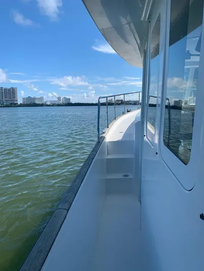  Yacht Photos Pics 2006 Beneteau Swift Trawler 42 cruising on calm waters under a clear blue sky.