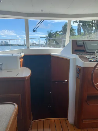  Yacht Photos Pics Interior view of 2006 Beneteau Swift Trawler 42 with wooden finishes and ocean backdrop.
