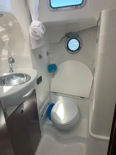  Yacht Photos Pics 2006 Beneteau Swift Trawler 42 bathroom with sink, toilet, and porthole window.