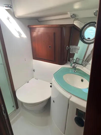  Yacht Photos Pics 2006 Beneteau Swift Trawler 42 bathroom with modern fixtures and wooden cabinetry.