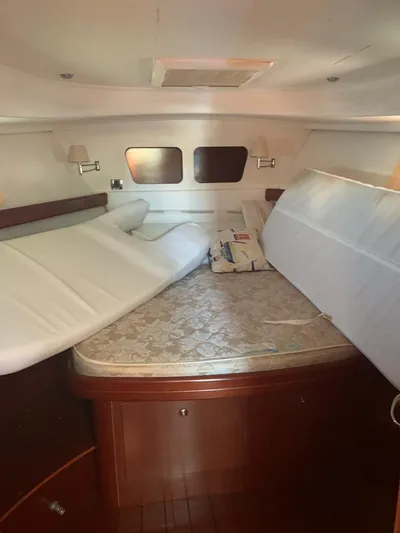  Yacht Photos Pics Interior cabin of 2006 Beneteau Swift Trawler 42 with bed and wooden furnishings.