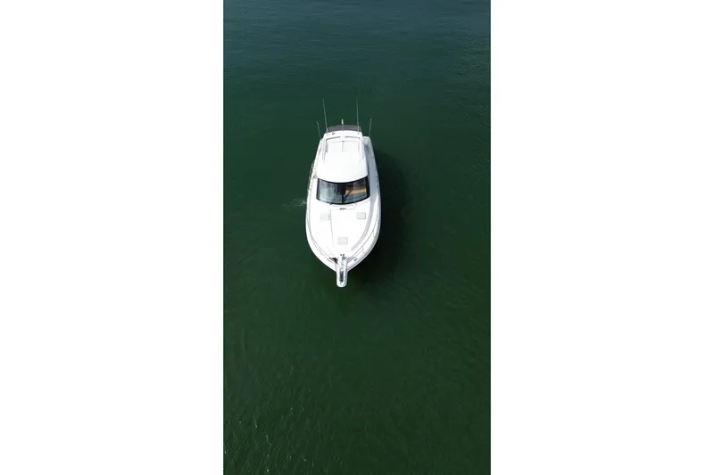  Yacht Photos Pics Aerial view of 2009 Riviera 4700 Sport Yacht cruising on calm water.