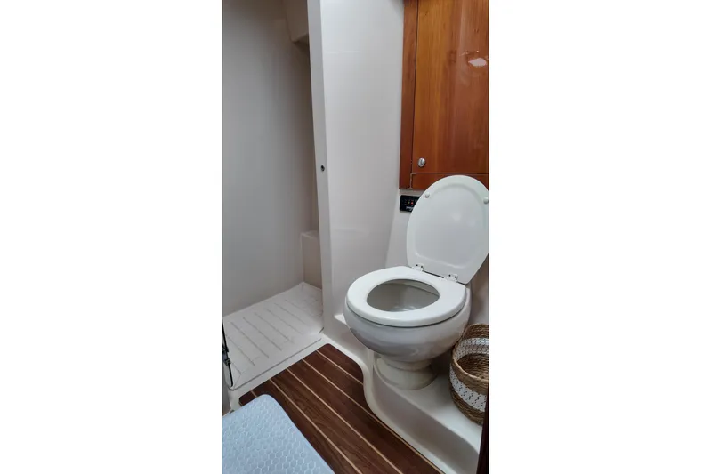  Yacht Photos Pics Bathroom interior of 2009 Riviera 4700 Sport Yacht with wooden accents and modern fixtures.