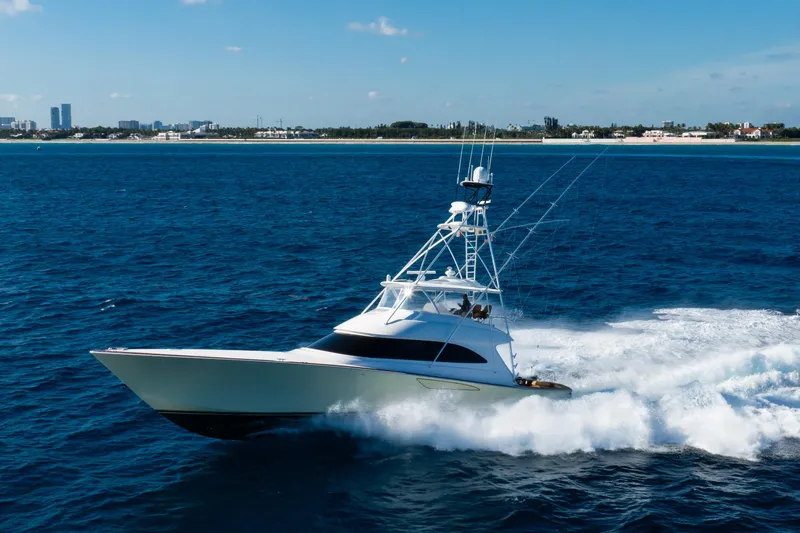 Pipe Dreamer Yacht Photos Pics 2015 Viking 70 Convertible yacht cruising on open blue ocean near coastline.