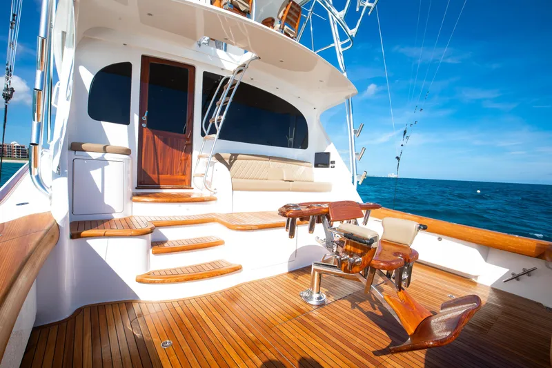 Pipe Dreamer Yacht Photos Pics Luxurious 2015 Viking 70 Convertible yacht deck with wooden finish and ocean view.
