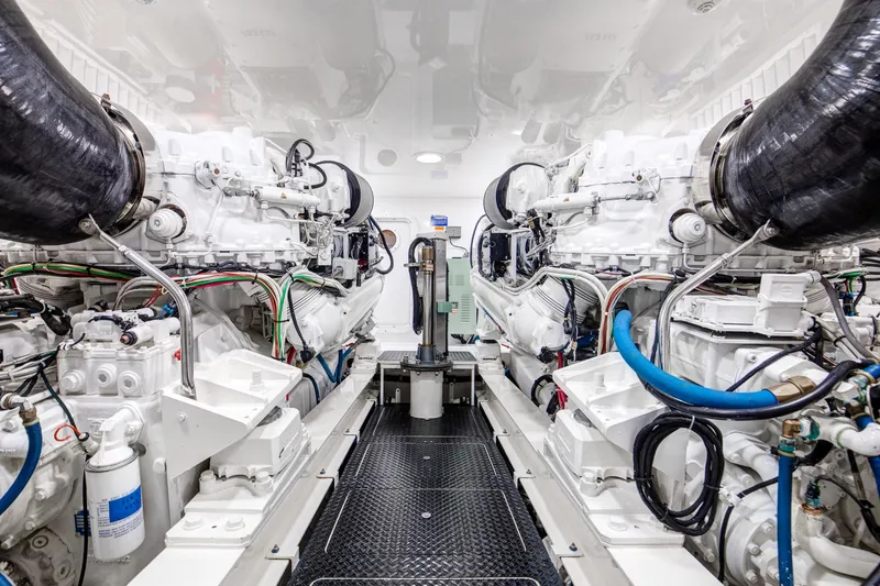 Pipe Dreamer Yacht Photos Pics Engine room of a 2015 Viking 70 Convertible yacht, showcasing dual engines and intricate piping.