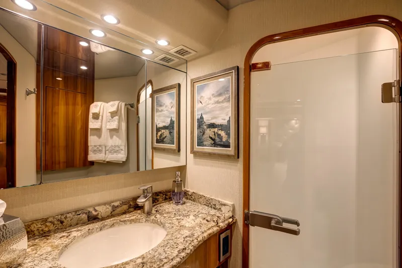 Pipe Dreamer Yacht Photos Pics Luxurious bathroom in 2015 Viking 70 Convertible yacht with granite countertop and elegant decor.