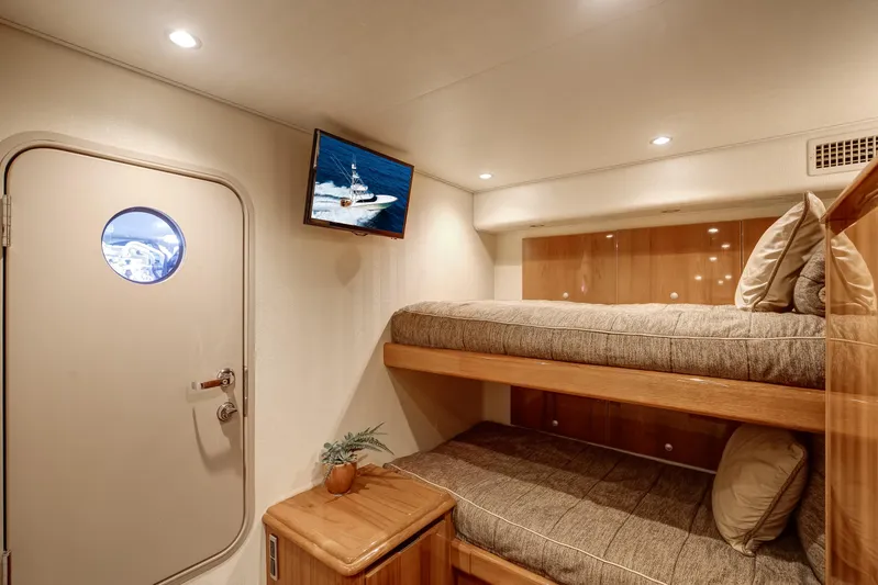 Pipe Dreamer Yacht Photos Pics Interior of 2015 Viking 70 Convertible yacht with bunk beds and TV.