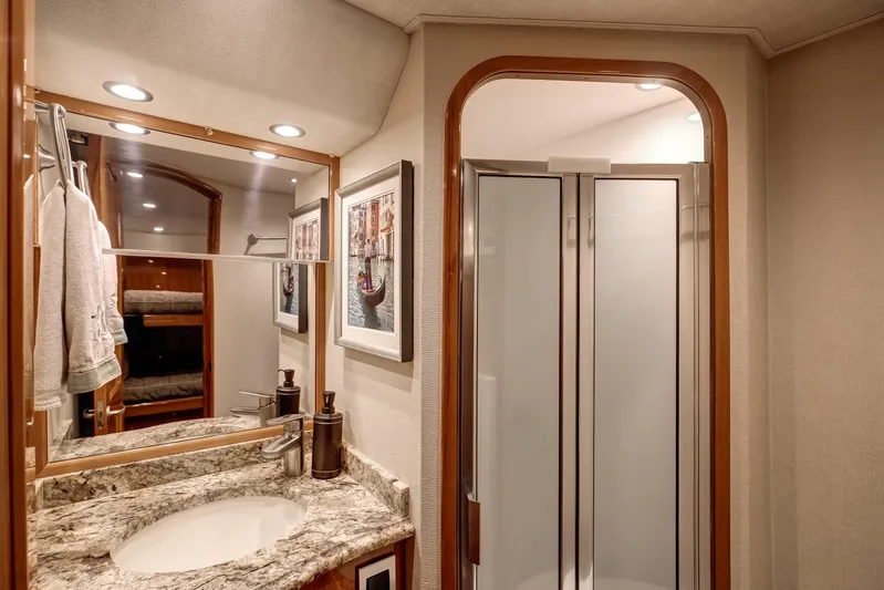 Pipe Dreamer Yacht Photos Pics Luxurious bathroom in 2015 Viking 70 Convertible yacht with granite countertop and shower.