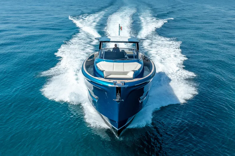  Yacht Photos Pics 2024 Solaris Power 52 Open yacht cruising on clear blue ocean waters.