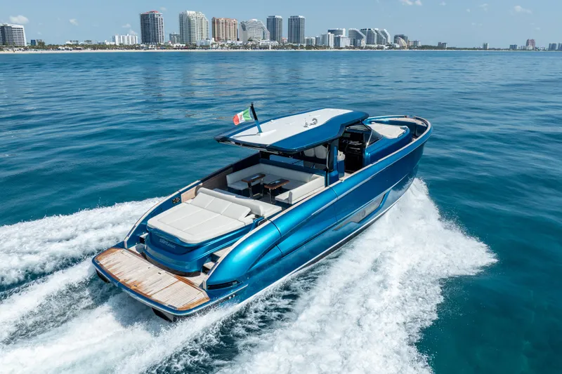  Yacht Photos Pics 2024 Solaris Power 52 Open yacht cruising on blue ocean near city skyline.