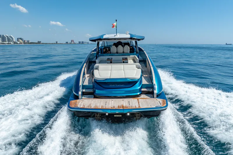  Yacht Photos Pics 2024 Solaris Power 52 Open yacht cruising on open sea, rear view.