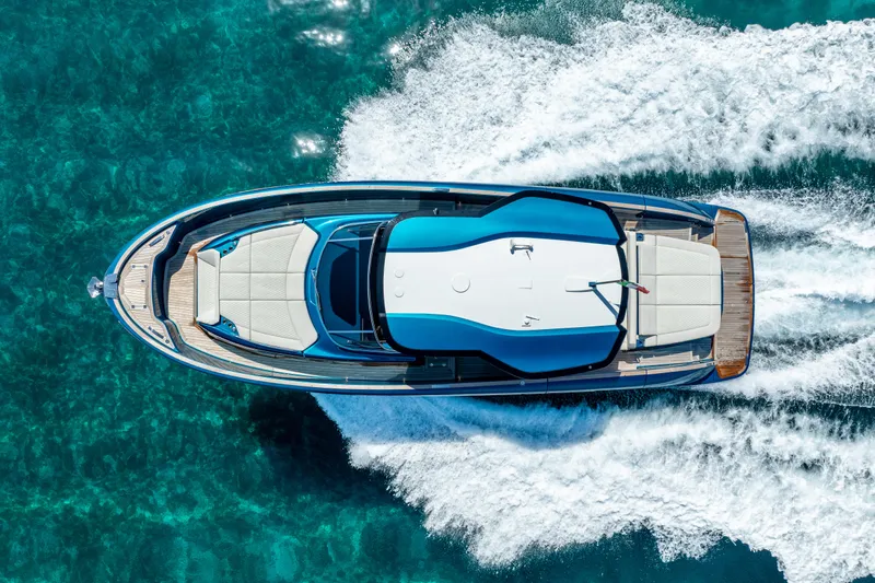  Yacht Photos Pics 2024 Solaris Power 52 Open yacht cruising on clear blue water, aerial view.