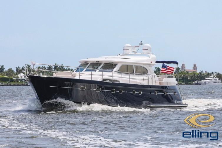 2025 Elling E6 Ultimate yacht cruising on water with American flag, palm trees in background.