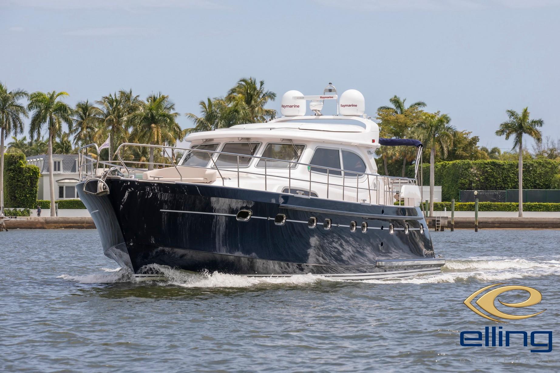2025 Elling E6 Ultimate yacht cruising on a sunny day with palm trees in the background.