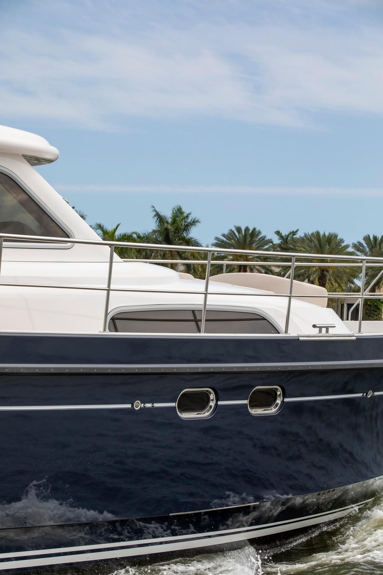 Elling E6 Ultimate 2025 yacht cruising with palm trees in the background.