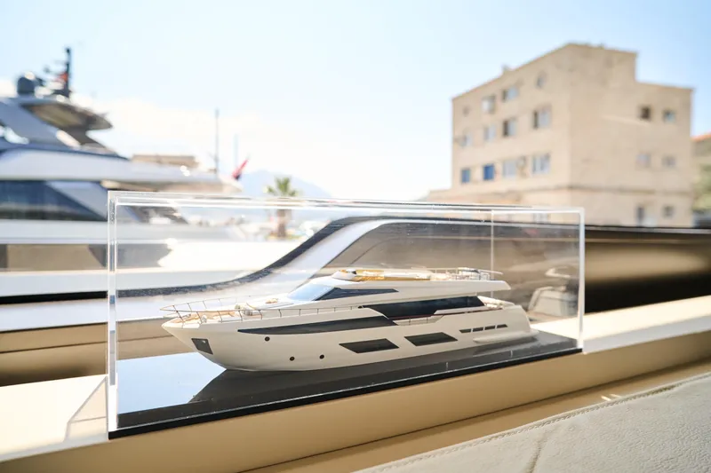  Yacht Photos Pics Model of 2023 Ferretti Yachts 920 displayed in a glass case on a yacht.