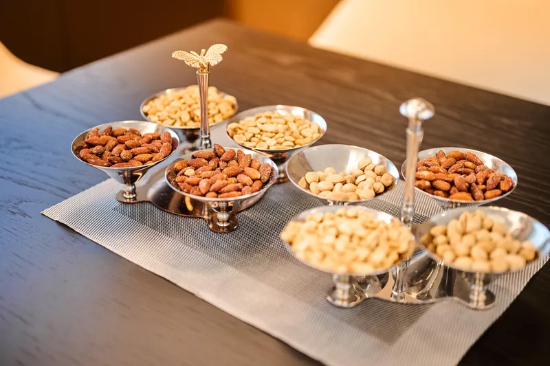  Yacht Photos Pics Elegant nut assortment on Ferretti Yachts 920, 2023 model, luxury dining setting.