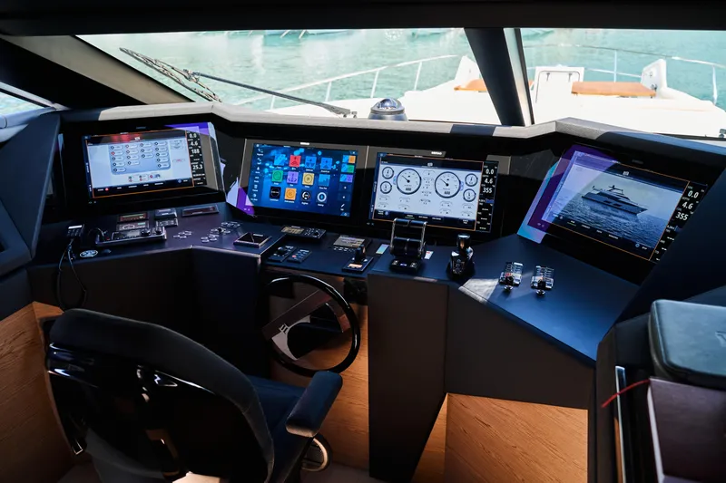 Yacht Photos Pics Control panel of 2023 Ferretti Yachts 920 with advanced navigation displays and steering wheel.
