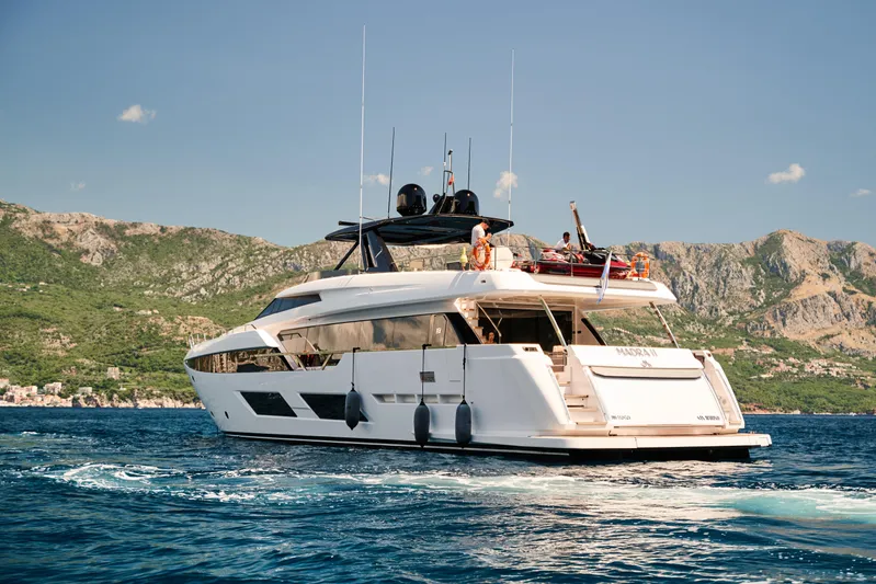 Yacht Photos Pics 2023 Ferretti Yachts 920 cruising on blue waters with scenic mountain backdrop.