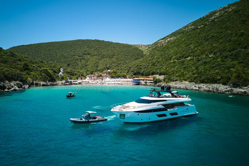  Yacht Photos Pics 2023 Ferretti Yachts 920 in a scenic bay with lush green hills.