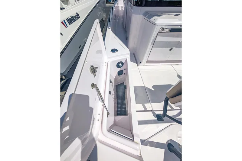 Yacht Photos Pics 2024 Axopar 37XC CROSS CABIN BRABUS Trim, showcasing sleek deck design and storage features.